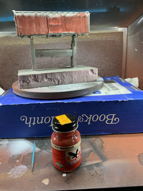 HO scale wood box car with a top layer of Rock Island Maroon paint.