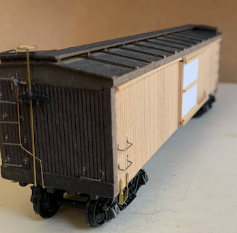 Assembled, unpainted HO scale box car, angle view, with a short depth of focus.