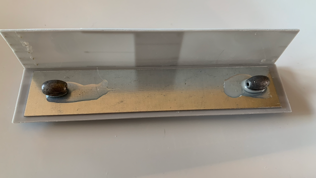 HO scale box car floor with one side attached. Weights on the floow are attached with a puddle of PVA glue.