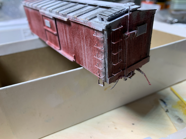 HO scale wooden box car with fresh gray tack boards on the sides and ends.
