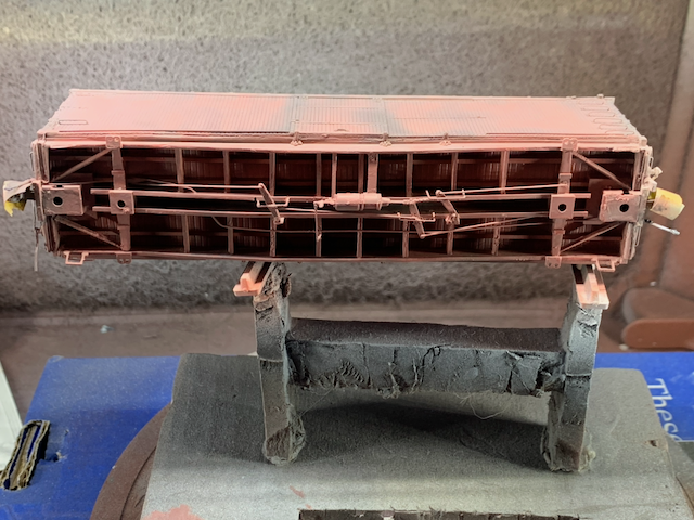 HO scale box car underside while being painted.