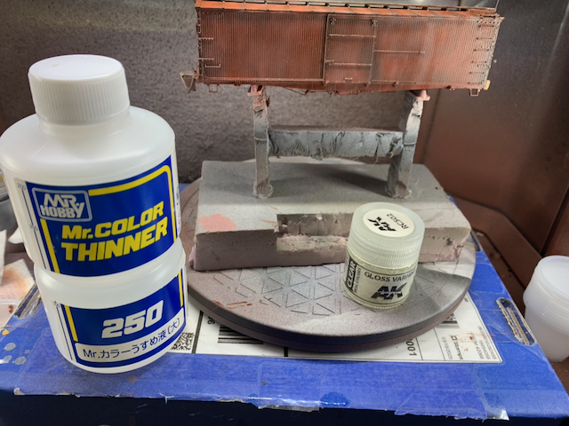 HO scale box car being gloss varnished.