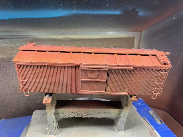 HO scale wooden box car with a layer of box car red (a mix of Rock Island Maroom and Tuscan Red).