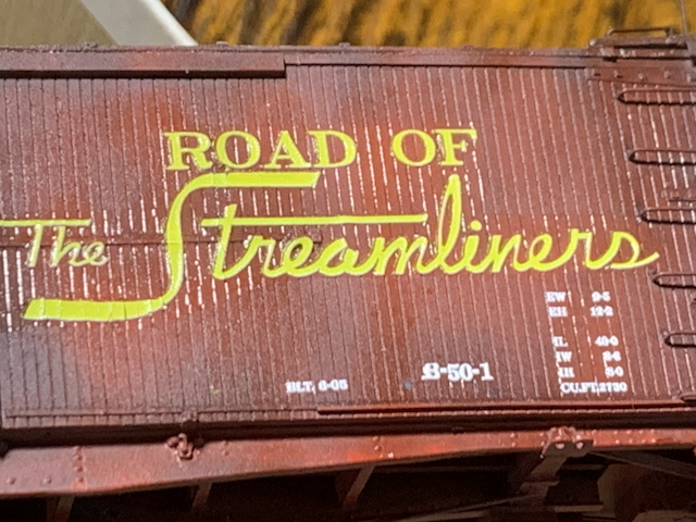 HO scale painted box car being decaled for Union Pacific. Close up of the Road of the Streamliners logo.