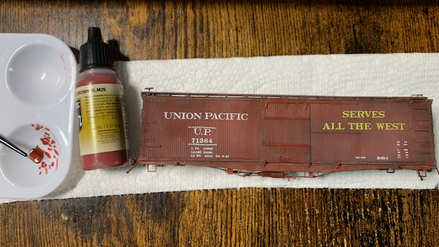HO scale UP box car having details highlighted in Vallejo Air Brown RLM26 acrylic, which is slightly redder and brighter than the base color.