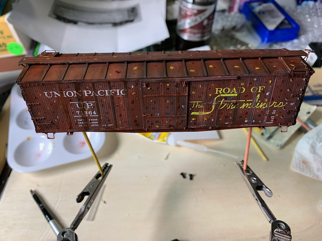 Dotting oils on the side of a UP box car in HO scale.