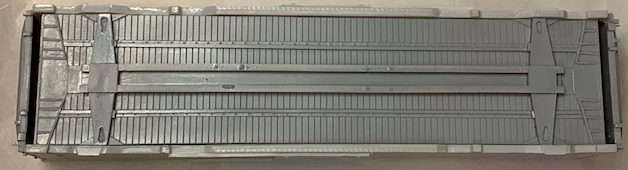 HO scale box car inverted showing that the floor is short compared to the sides and roof.