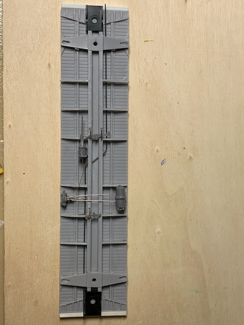 HO scale box car floor with brake detail installed.