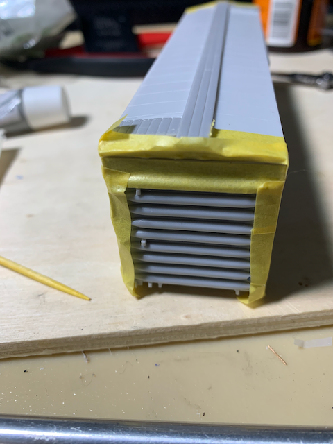 HO scale box car end masked for filling the gap between roof and end casting.