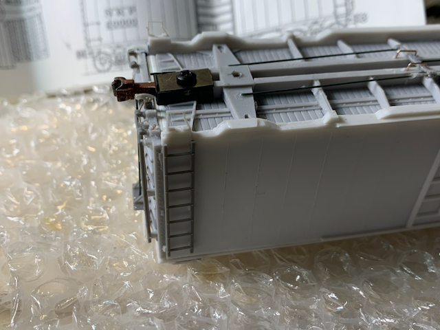 HO scale box car cut lever installation: eyebolts. Note the long shank on the coupler.