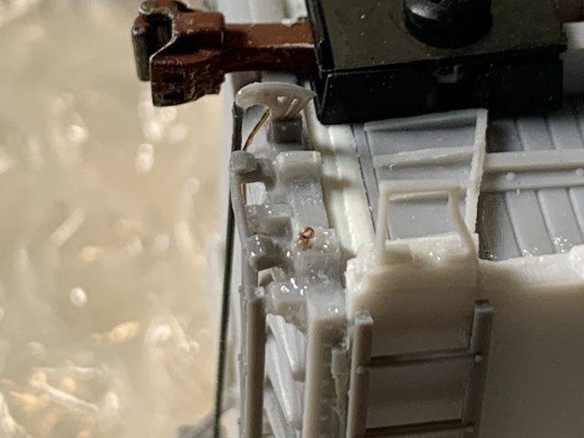 HO scale box car cut lever installation: eyebolts. Note the long shank on the coupler. Close-up.