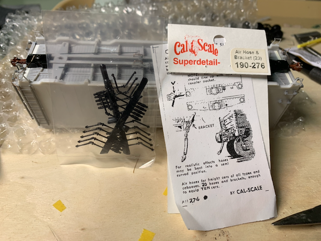 HO scale box car with a newly opened package of Cal Scale Air Hose & Bracket (20) part 190-276.