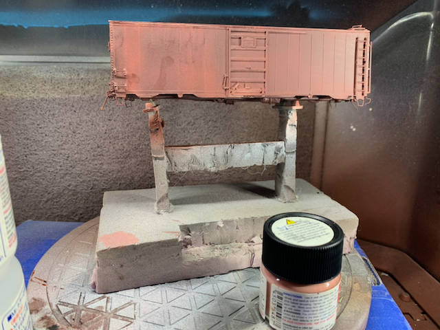 HO scale box car with a light coat of brownish pink highlights.